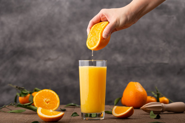 glass-orange-juice-person-squeezing-orange-it_181624-1070